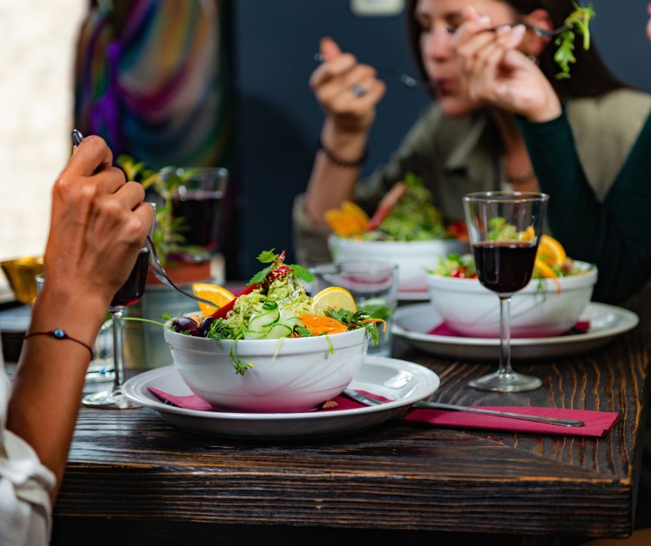 Seattle's Vibrant Food Scene: People eating salads and drinking wine in seattle restaurant