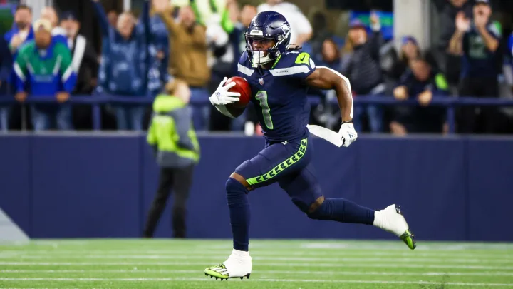 A Seattle Seahawk player running across the field