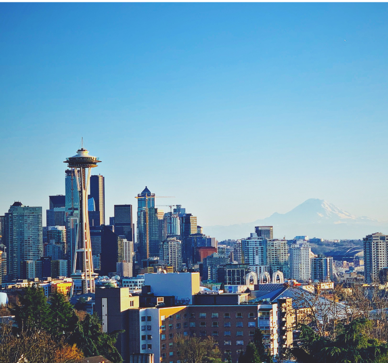 seattle_downtown_view_space_needle Scenic view of downtown Seattle with the Space Needle and Mount Rainier in the background—ideal city for corporate housing and entertainment.