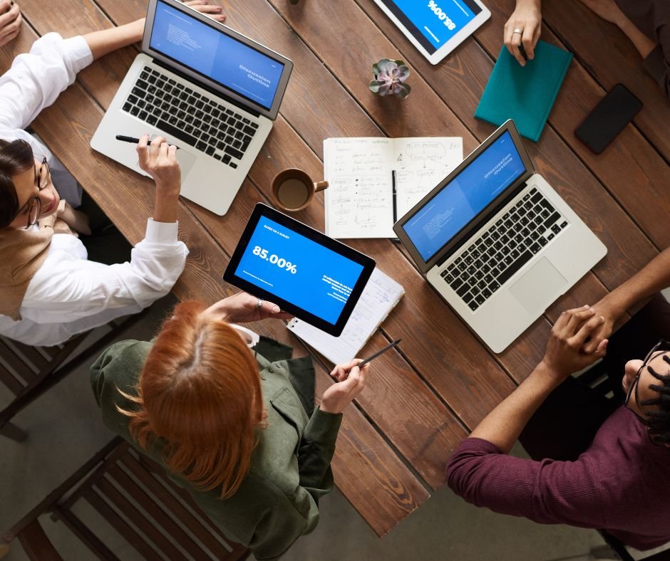 young professionals working on their electronic devices calculating numbers for a project in a seattle for an internship